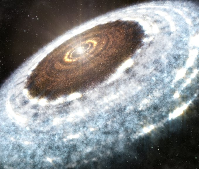 An artist's illustration shows the water snow line detected around the young star V883 Orionis — the delineation between where the hot star vaporizes all water, leaving rocky dust and debris, and where ice and snow exist in the disk. Credit: A. Angelich (NRAO/AUI/NSF)/ALMA (ESO/NAOJ/NRAO) 