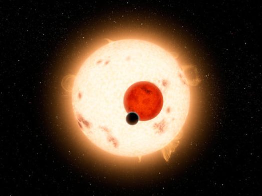 An artist's rendering of the Kepler-16 system, showing the binary star being orbited by Kepler-16b