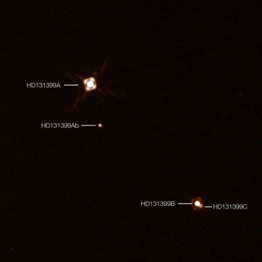 This annotated composite image shows the newly discovered exoplanet HD 131399Ab in the triple-star system HD 131399. The image of the planet was obtained with the SPHERE imager on the ESO Very Large Telescope in Chile. This is the first exoplanet to be discovered by SPHERE and one of very few directly-imaged planets. With a temperature of around 580 degrees Celsius and an estimated mass of four Jupiter masses, it is also one of the coldest and least massive directly-imaged exoplanets. This picture was created from two separate SPHERE observations: one to image the three stars and one to detect the faint planet. The planet appears vastly brighter in this image than in would in reality in comparison to the stars.