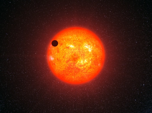 The planet Gliese 1214b was initially described as a possible "water world," and the idea caught the public imagination. But subsequent examination, and the characterizing of other super-Earths and sub-Neptunes, has led to a different conclusion: that the planet is most likely covered by a hydrogen/helium envelope and a thick film of sooty dust. (Artist rendering by L. Calçada, European Space Observatory.)